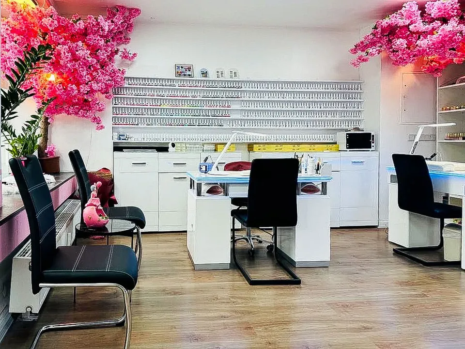Helles Studio mit Maniküre-Plätzen und rosa Kirschblüten